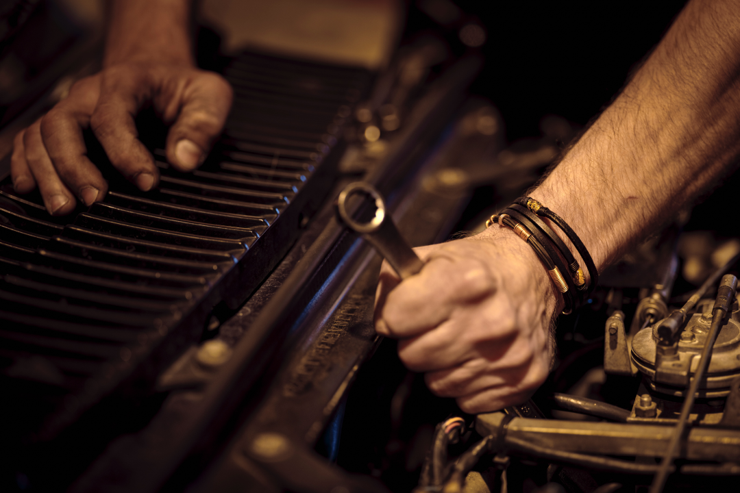 Mechanic working on a machine with a spanner