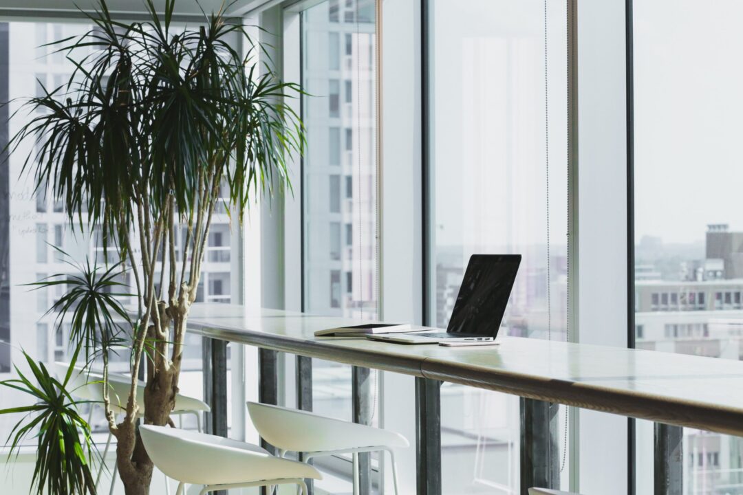 Office equipment on a desk in front of a window